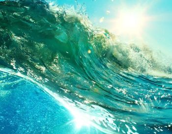 Ocean wave reflecting sunshine close up image